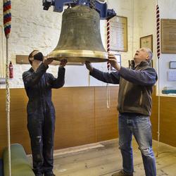 Jack Knowles and Nick Powell guide the bell at the ringing platform. Photo: Nigel Francis